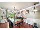 Formal dining room with hardwood floors, elegant lighting, and large windows at 1520 Windsong Park Dr, Dacula, GA 30019