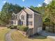 Charming brick residence featuring manicured landscaping, a circular driveway, and a two-car garage at 1520 Windsong Park Dr, Dacula, GA 30019