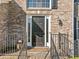 Close up of a brick house entrance, featuring a dark front door with sidelights and decorative lanterns at 1520 Windsong Park Dr, Dacula, GA 30019