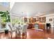Open-concept kitchen with rich wood cabinets, stainless steel appliances, and an adjacent dining area at 1520 Windsong Park Dr, Dacula, GA 30019