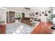 Open living room with hardwood floors, barn doors, and decorative guitars on the wall at 1520 Windsong Park Dr, Dacula, GA 30019