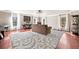 Spacious living room featuring hardwood floors, large windows, and a decorative rug at 1520 Windsong Park Dr, Dacula, GA 30019