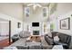 Inviting living room with a fireplace, plush seating, and ample natural light, creating a cozy atmosphere at 1520 Windsong Park Dr, Dacula, GA 30019