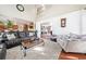 Inviting living room with plush seating, hardwood floors, and lots of natural light at 1520 Windsong Park Dr, Dacula, GA 30019