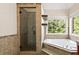 Bathroom features a corner soaking tub and tiled glass door shower at 1520 Windsong Park Dr, Dacula, GA 30019