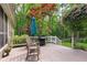 Outdoor deck with a grill and seating area amidst a scenic backyard with towering trees at 2140 Azalea Dr, Roswell, GA 30075