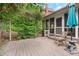 Relaxing backyard patio with wooden deck and stone accents amidst lush landscaping at 2140 Azalea Dr, Roswell, GA 30075