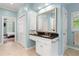 Bathroom with dual vanities, a sink, and views into the main bedroom and closet at 2140 Azalea Dr, Roswell, GA 30075