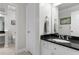 Bathroom with white vanity, black countertop, and chrome fixtures, exuding classic elegance at 2140 Azalea Dr, Roswell, GA 30075