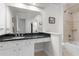 Bathroom showcasing white cabinets, black granite counters and a shower-tub combination at 2140 Azalea Dr, Roswell, GA 30075
