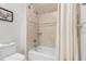 Bathroom featuring tiled shower-tub combination, toilet, and framed artwork at 2140 Azalea Dr, Roswell, GA 30075