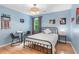 Blue bedroom with a black metal bed frame, sports decorations, and hardwood floors at 2140 Azalea Dr, Roswell, GA 30075