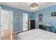 Comfortable blue bedroom with hardwood floors, natural light, and ample space at 2140 Azalea Dr, Roswell, GA 30075