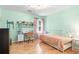 Charming bedroom with light green walls, hardwood floors, a comfortable bed, and a well-lit study area at 2140 Azalea Dr, Roswell, GA 30075
