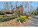 Community entrance with brick sign surrounded by landscaping and mature trees at 2140 Azalea Dr, Roswell, GA 30075