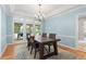 Light blue dining room featuring wood floors, chandelier, and a view to the outside patio at 2140 Azalea Dr, Roswell, GA 30075