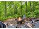 Outdoor fire pit area with comfortable seating surrounded by lush greenery at 2140 Azalea Dr, Roswell, GA 30075