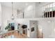 Bright foyer showcasing an elegant hanging light, hardwood floors, and an open view to the living spaces below at 2140 Azalea Dr, Roswell, GA 30075