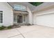 Close up view of a charming home with a 2-car garage and covered entryway featuring a double door at 2140 Azalea Dr, Roswell, GA 30075