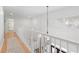 Upstairs hallway with natural light, hardwood floors, and white railings, providing an airy and bright passageway at 2140 Azalea Dr, Roswell, GA 30075
