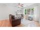 Inviting living room featuring large windows, hardwood floors, and a comfortable sitting area with ample light at 2140 Azalea Dr, Roswell, GA 30075