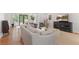 Spacious living room boasts hardwood floors, neutral tones, and views into other living spaces at 2140 Azalea Dr, Roswell, GA 30075