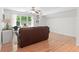 Well-lit living room with hardwood floors, showcasing a comfortable brown couch and bright, natural light at 2140 Azalea Dr, Roswell, GA 30075