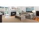 Open-concept living room featuring a fireplace and doors leading to a sunroom and dining room at 2140 Azalea Dr, Roswell, GA 30075