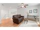 Cozy living room with a ceiling fan, hardwood floors, and a comfortable brown couch for relaxation at 2140 Azalea Dr, Roswell, GA 30075