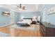 Spacious primary bedroom featuring a tray ceiling, ceiling fan, and a bench at the foot of the bed at 2140 Azalea Dr, Roswell, GA 30075