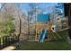 Backyard wooden playset with slide on a green lawn, offering a fun space for children at 2140 Azalea Dr, Roswell, GA 30075