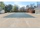 Backyard pool with secure safety cover, next to brick house, surrounded by mature trees for privacy at 2140 Azalea Dr, Roswell, GA 30075