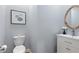 Simple powder room with decorative mirror, a modern vanity, and neutral colors at 2140 Azalea Dr, Roswell, GA 30075