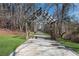 Entrance to the Roswell Riverwalk, a scenic paved path surrounded by trees at 2140 Azalea Dr, Roswell, GA 30075
