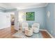 Sitting area boasting two armchairs, a small table, and an art piece adding charm to the space at 2140 Azalea Dr, Roswell, GA 30075