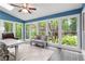 Bright sunroom with large windows offering views of the lush, surrounding greenery at 2140 Azalea Dr, Roswell, GA 30075