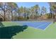 Community tennis courts surrounded by mature trees providing shade and privacy for residents at 2140 Azalea Dr, Roswell, GA 30075