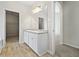 Bathroom showcasing a double vanity with neutral countertops and an adjacent walk-in closet at 498 Charleston Pl, Villa Rica, GA 30180