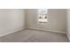Bedroom with neutral walls, carpet, and a window showcasing an exterior view at 498 Charleston Pl, Villa Rica, GA 30180