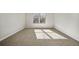 Bright bedroom featuring neutral walls, carpet, and a window offering natural light at 498 Charleston Pl, Villa Rica, GA 30180