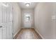 Bright entryway featuring hardwood floors and white door with a glimpse of backyard at 498 Charleston Pl, Villa Rica, GA 30180