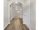 Inviting hallway with arched doorways and modern hardwood floors and neutral paint color at 498 Charleston Pl, Villa Rica, GA 30180