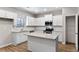 Attractive kitchen with white cabinets, stainless appliances, granite counters, and center island for food prep at 498 Charleston Pl, Villa Rica, GA 30180