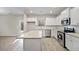 Well-lit kitchen featuring white cabinetry, granite countertops, and stainless steel appliances at 498 Charleston Pl, Villa Rica, GA 30180