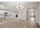 Open concept living space showing the kitchen, a fireplace, and an open doorway to the entry at 498 Charleston Pl, Villa Rica, GA 30180