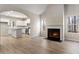 Living room with fireplace and views of the kitchen, featuring an open-concept design and hardwood floors at 498 Charleston Pl, Villa Rica, GA 30180