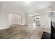 Open-concept living room area with modern fireplace, hardwood floors, and a kitchen in the background at 498 Charleston Pl, Villa Rica, GA 30180