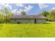 Exterior view of the house with double doors overlooking a large, grassy yard at 67 Jennifer Ln, Rydal, GA 30171
