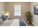 Cozy bedroom featuring a serene atmosphere with a plant, lamp, and window at 67 Jennifer Ln, Rydal, GA 30171