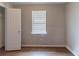 A neutral bedroom with a window and standard closet at 67 Jennifer Ln, Rydal, GA 30171